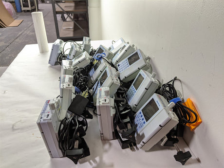 Baxter Sigma Spectrum Infusion Pump | Lot of 27 | Pole Clamps and AC Adapters