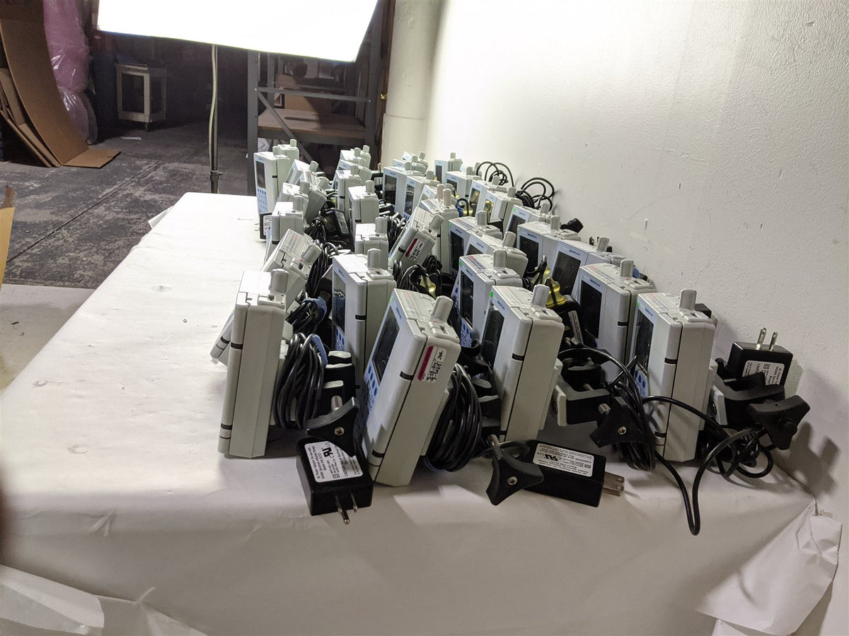 Baxter Sigma Spectrum Infusion Pump | Lot of 27 | Pole Clamps and AC Adapters